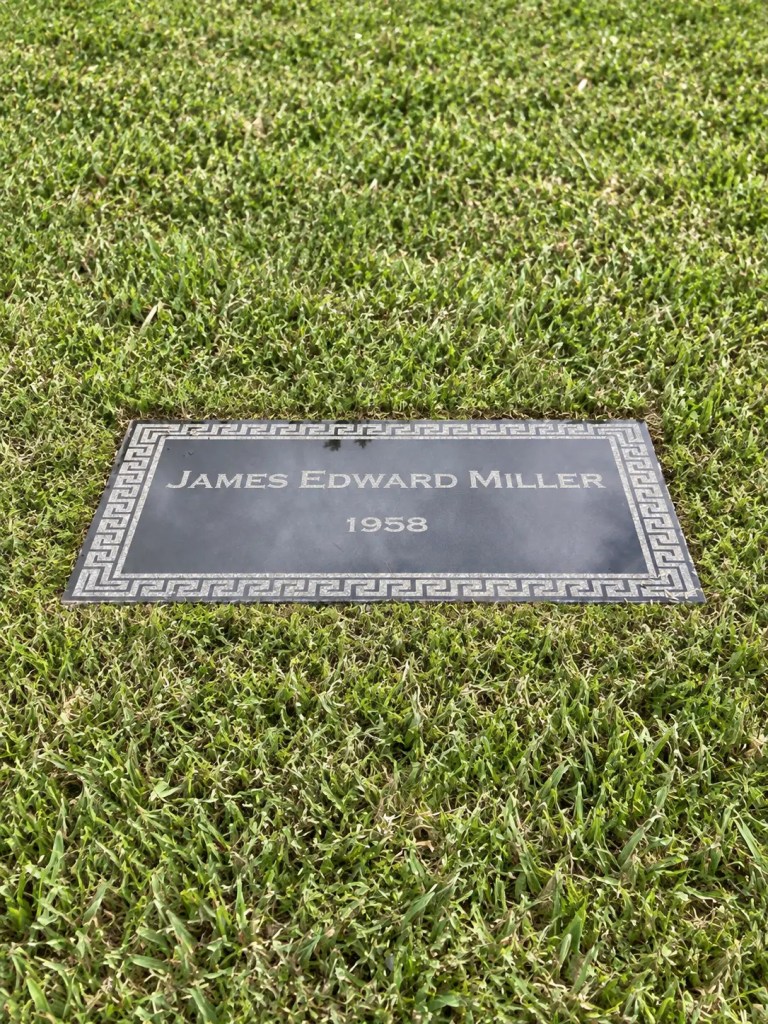 A Pursell Cremorial: a flat granite marker set level with the lawn, laser-engraved with a name and year inside a Greek key border